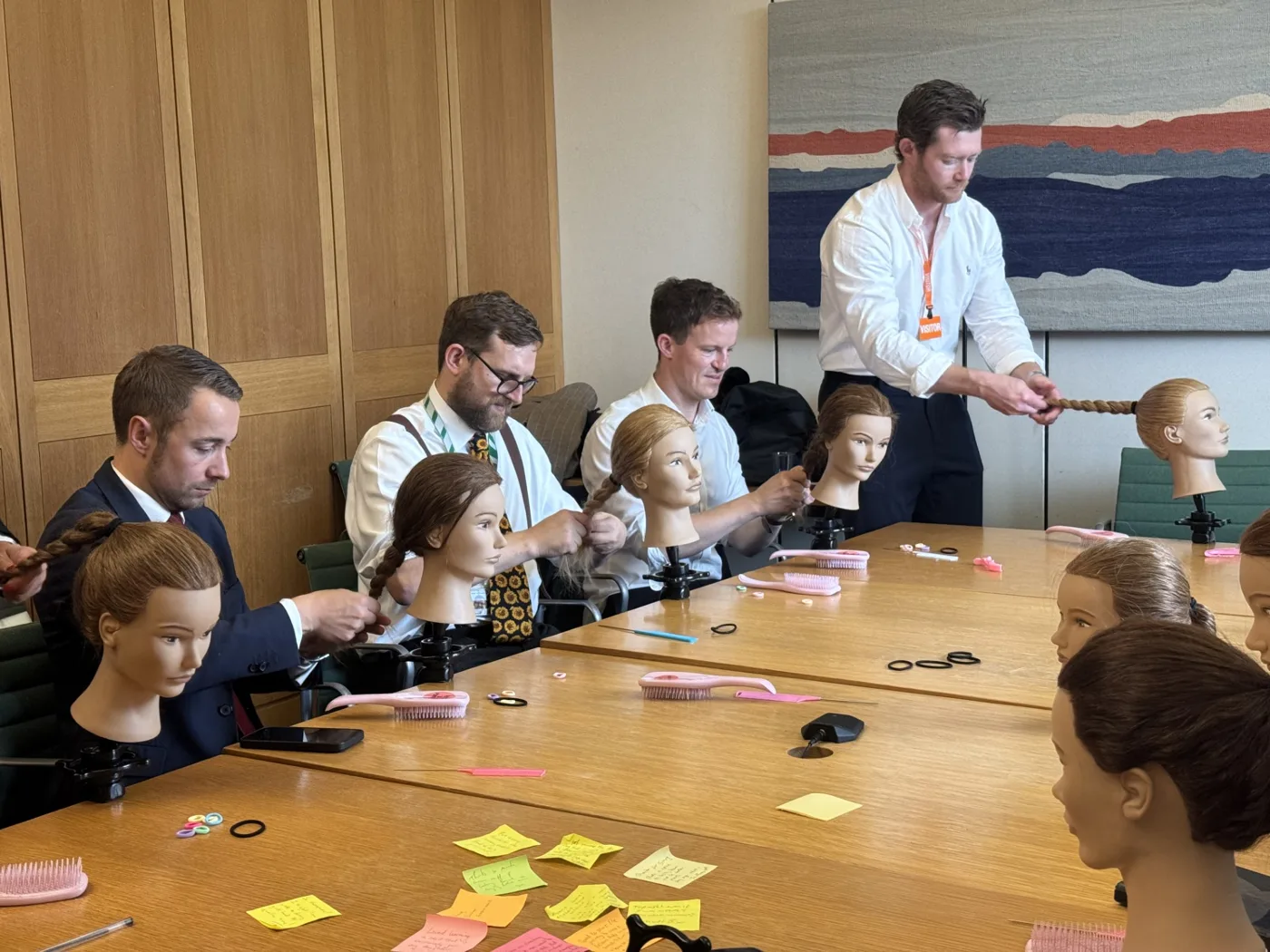 Pints & Ponytails session in Parliament, with plaits under way on practice heads