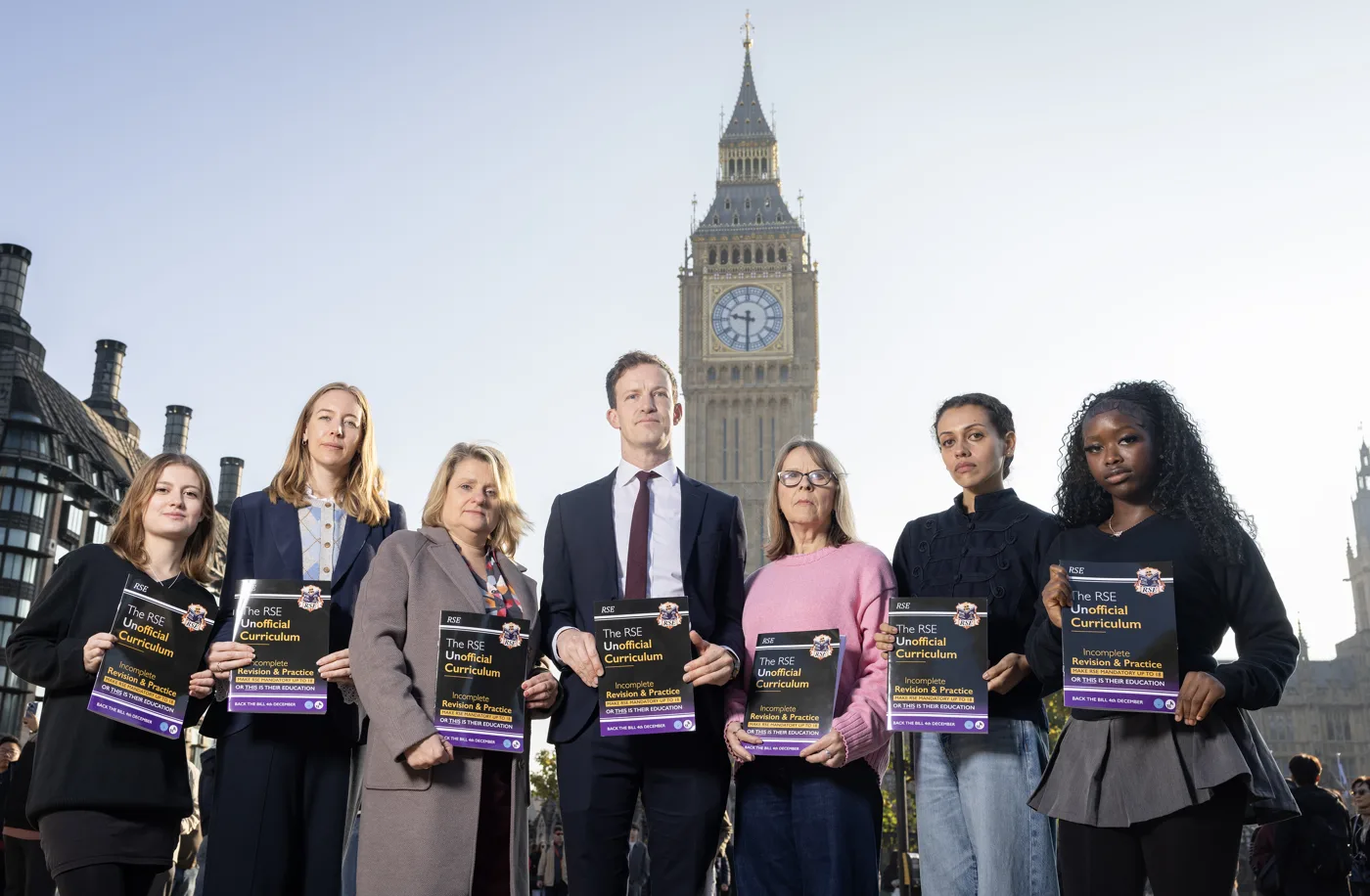 Alistair Strathern MP with campaigners holding copies of the RSE Unofficial Curriculum in Parliament Square