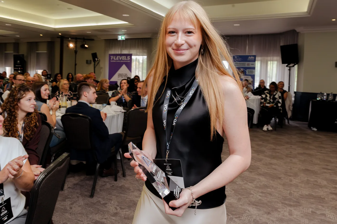 Maya Steeley holding her T Level Student of the Year award at the East of England regional finals
