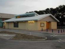 The single-storey Stevenage Community Arts Centre building with its lit entrance and sign